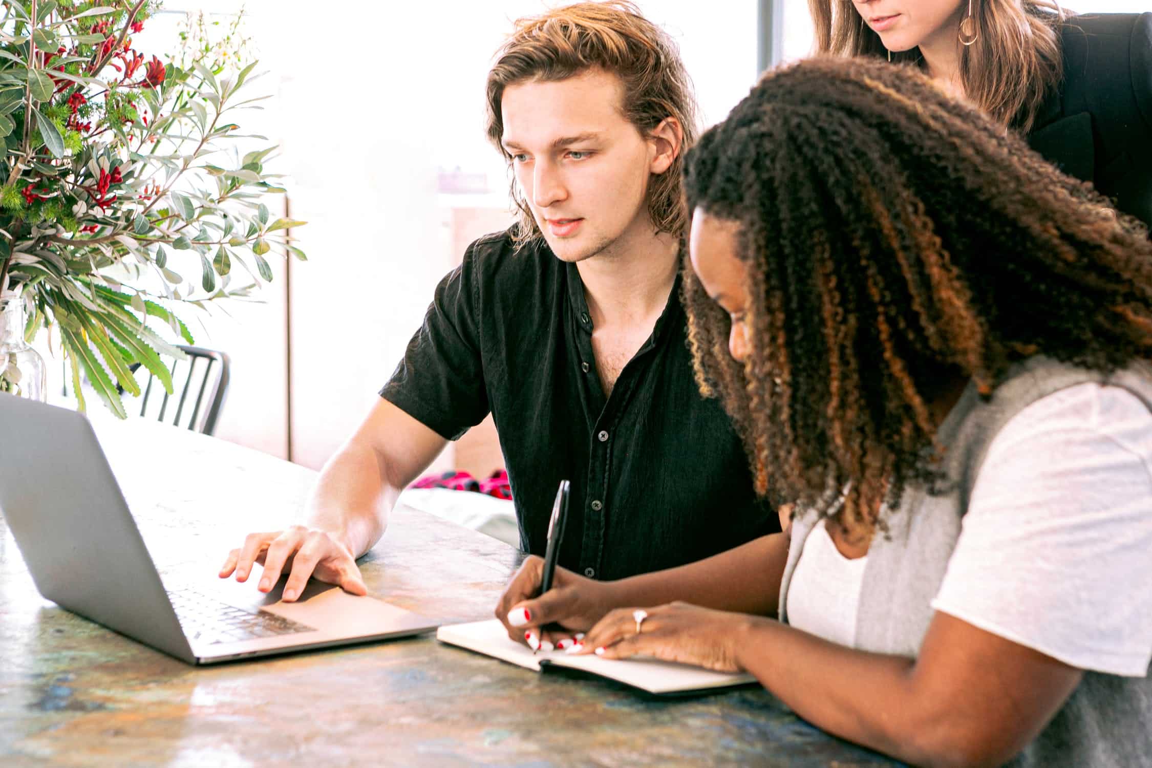 professionals collaborating around a laptop computer