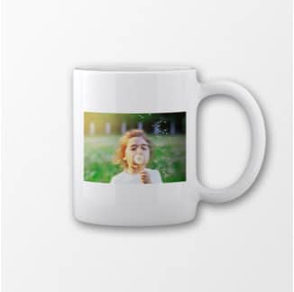 Mug with young girl blowing bubbles