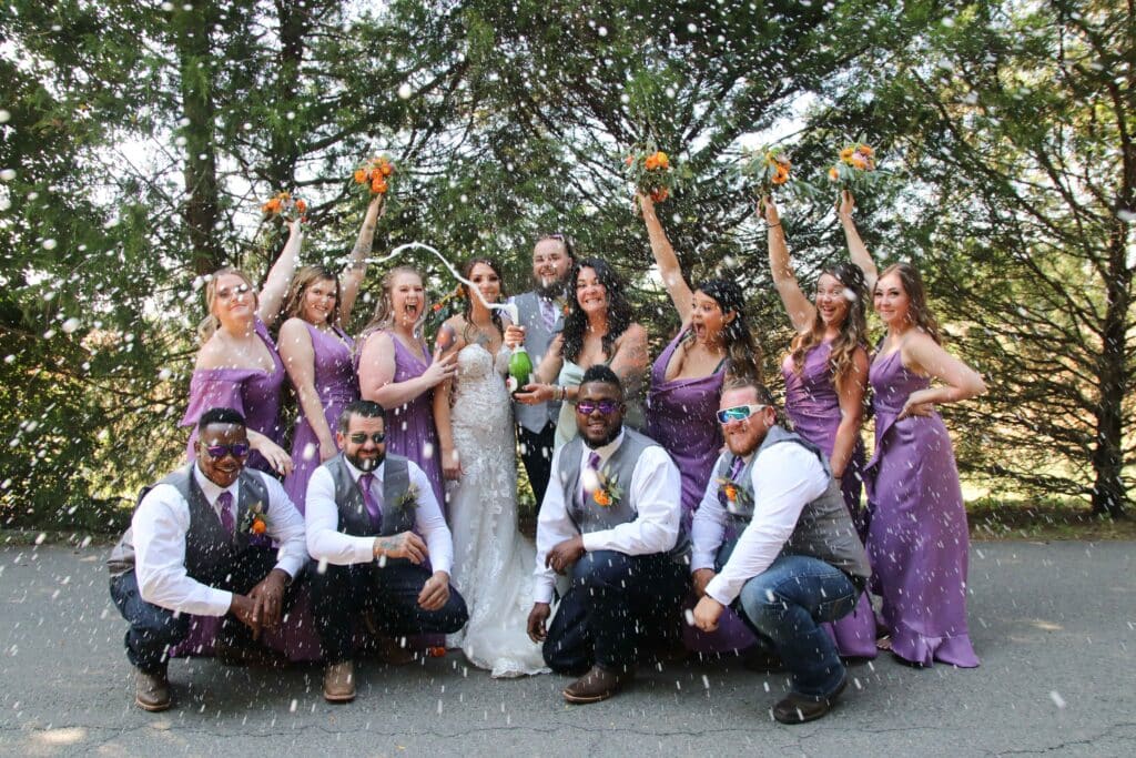 full bridal party with champagne spray photo credit Katera Gousy