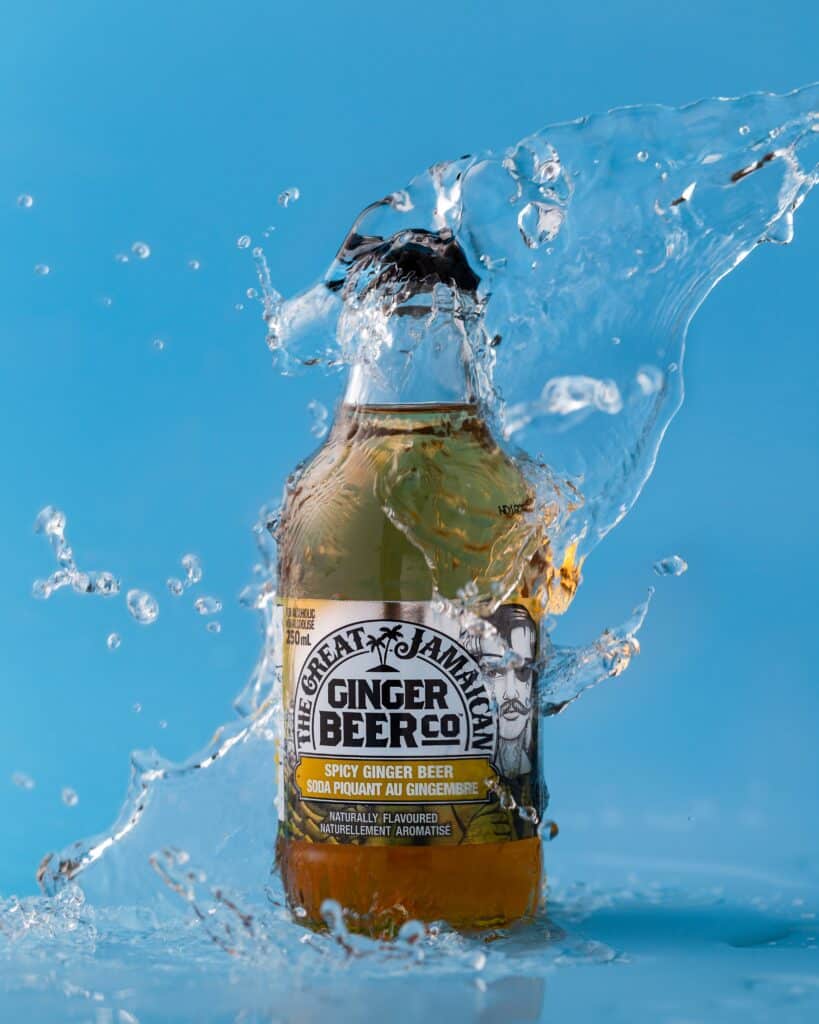 bottle of ginger beer being splashed with water