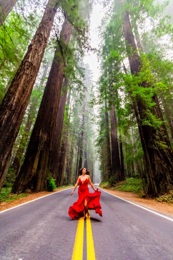 Laura Grier woman in red amidst the redwoods