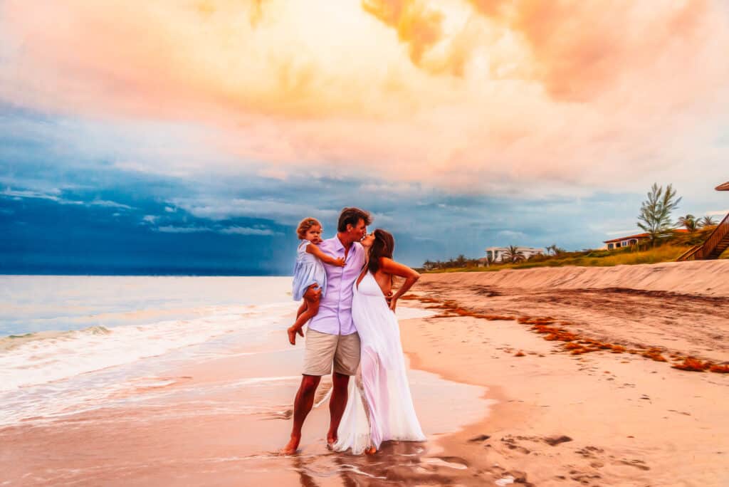mother husband child Maternity session at sunset on beach
