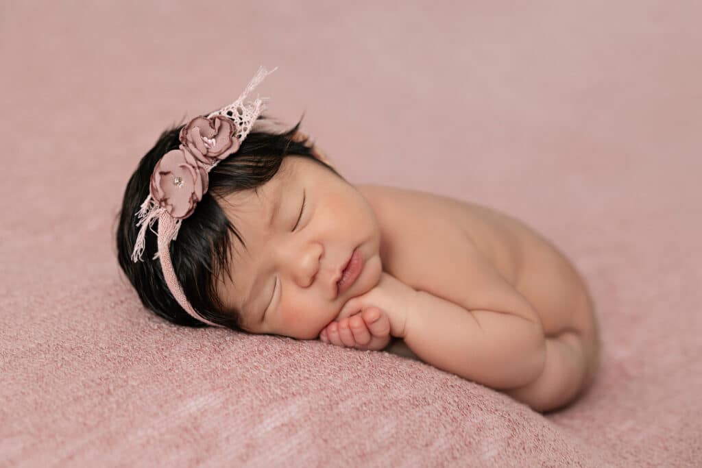 Image by Stephanie Schnautz: a baby posed resting head on arms