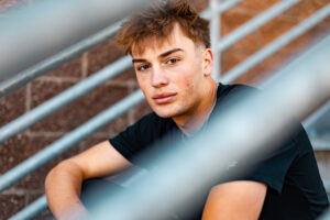 Senior picture pose ideas for guys: 14 easy standing and sitting poses.