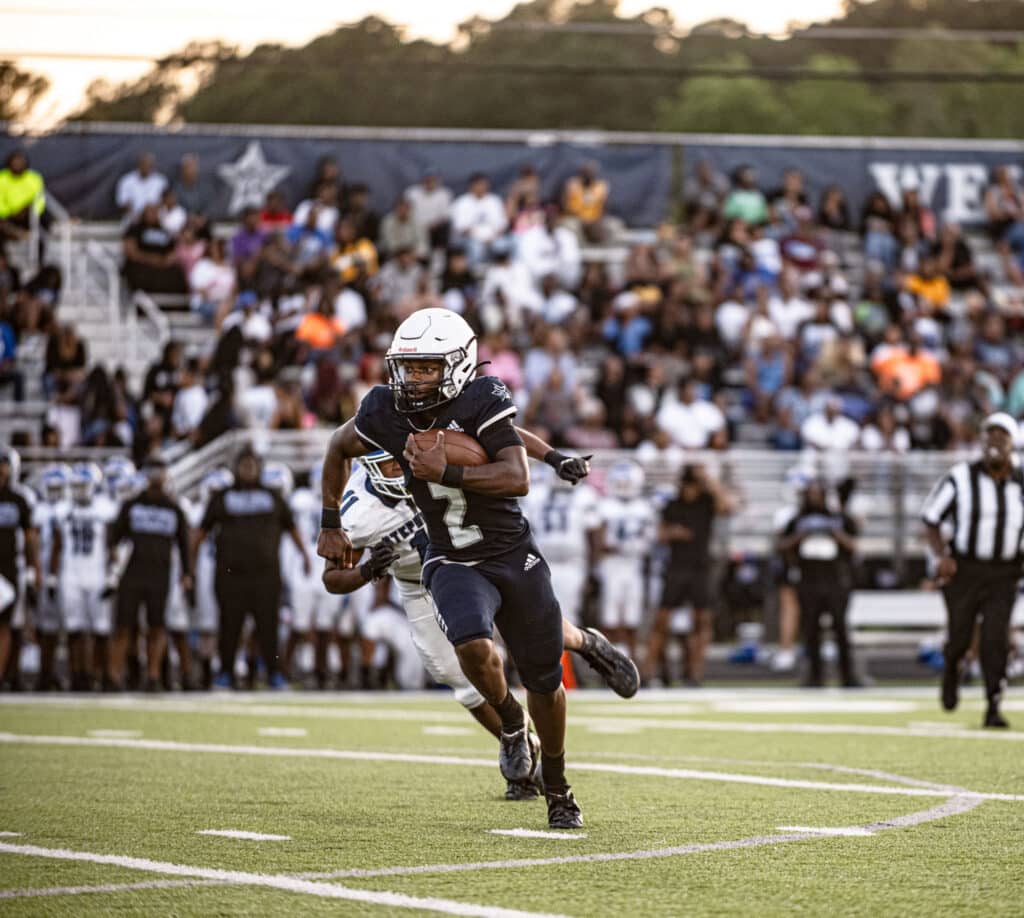 highschool football player running with ball on field Mark Mascoll