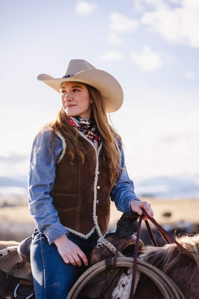 girl wearing cowboy hat and riding horse photo by Samantha DeCosta