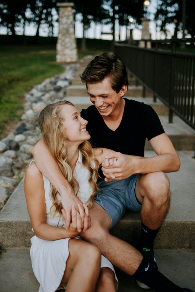 young couple portrait on stone steps at park