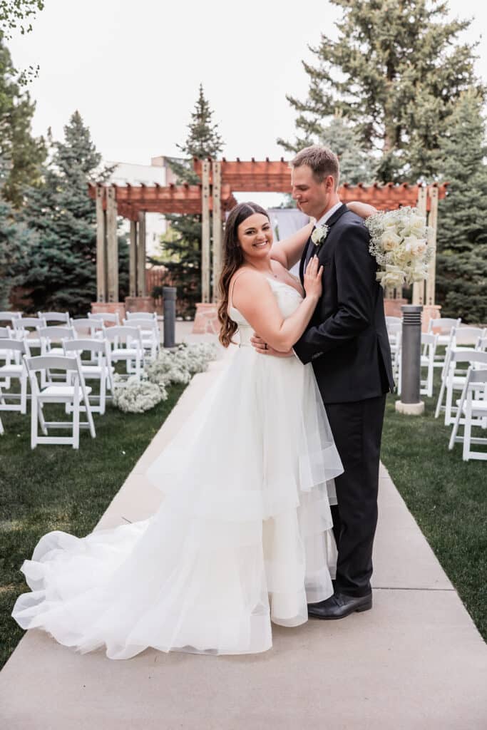 wedding couple posed in aisle at outdoor ceremony. Photo by Savannah Thompson