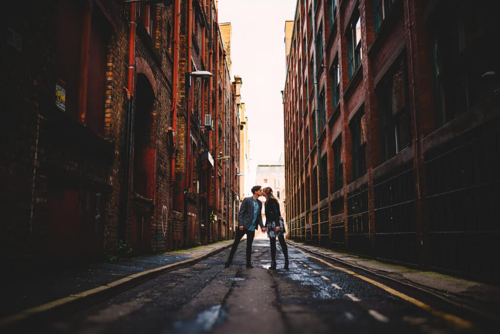 Steve Bridgwood Engaged couple kissing in an alley