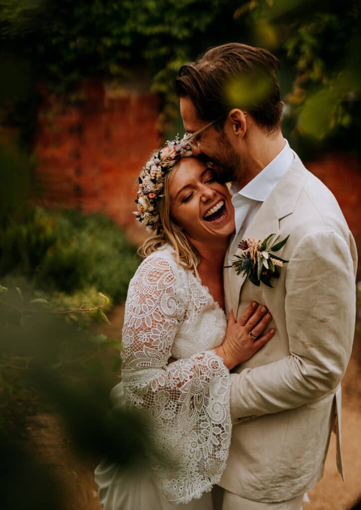wedding couple holding each other closely and laughing Steve Bridgwood photography