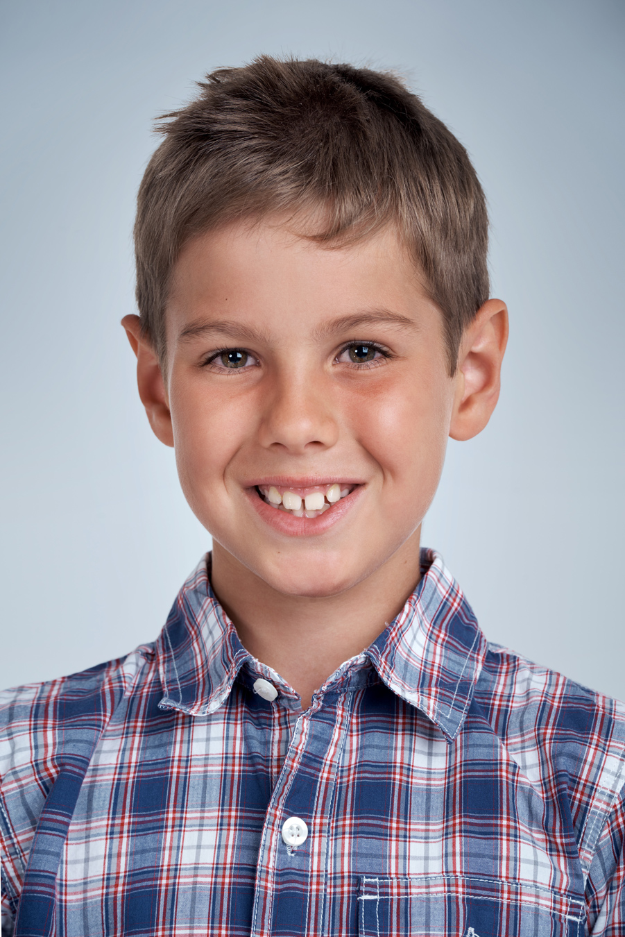 Boy in plaid shirt smiling school portrait 479361010