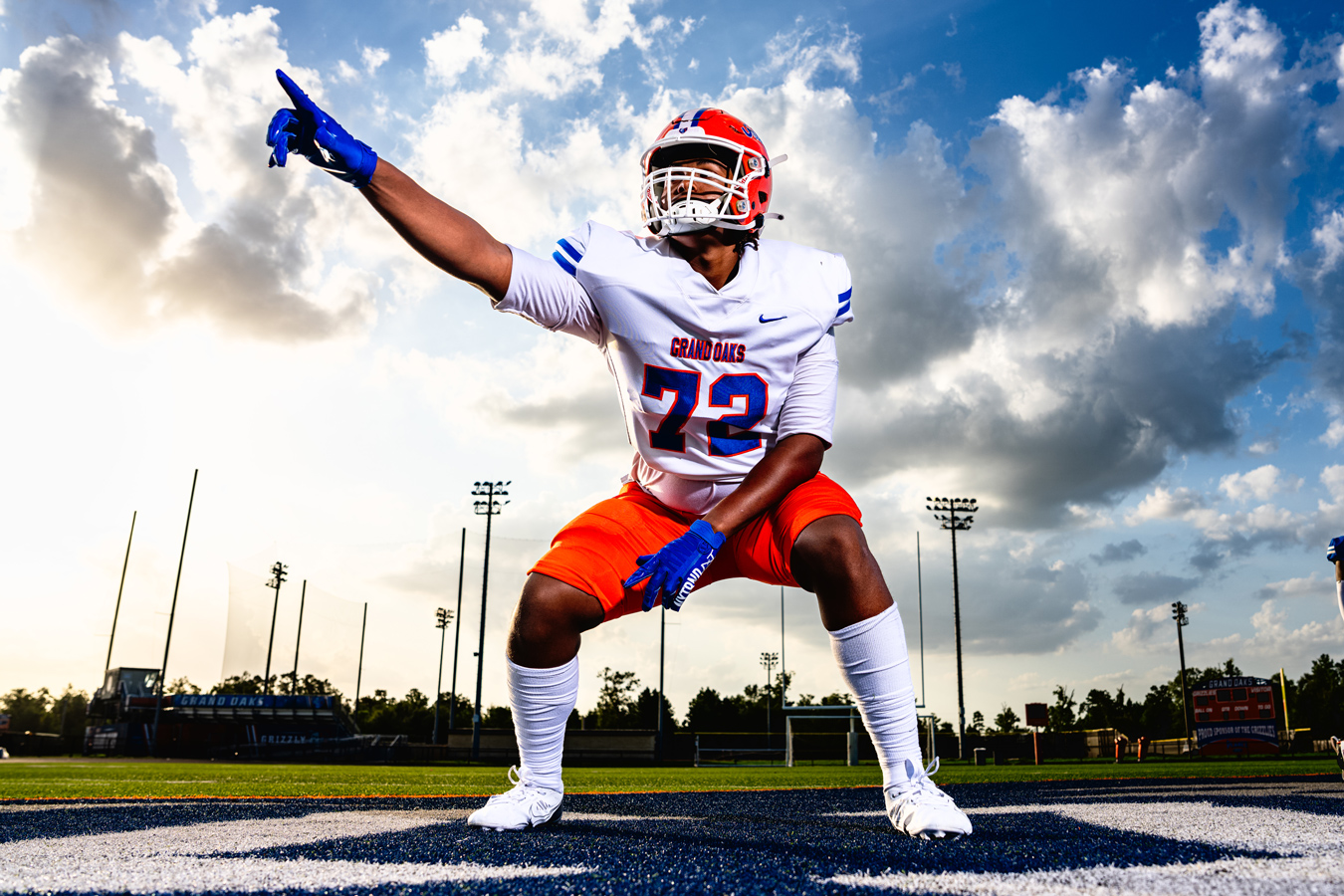 Football player, number 72, in Grand Oaks jersey, points, dynamic low angle. Image by Seth Fontenot Photography
