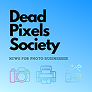 The Dead Pixels Society logo is displayed in bold black text above the tagline NEWS FOR PHOTO SUBMISSION on a blue gradient background, with three colorful line-art icons representing a camera, printer, and landscape.