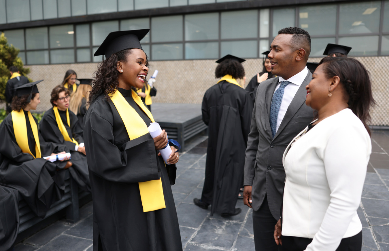 female graduate talking to parents
