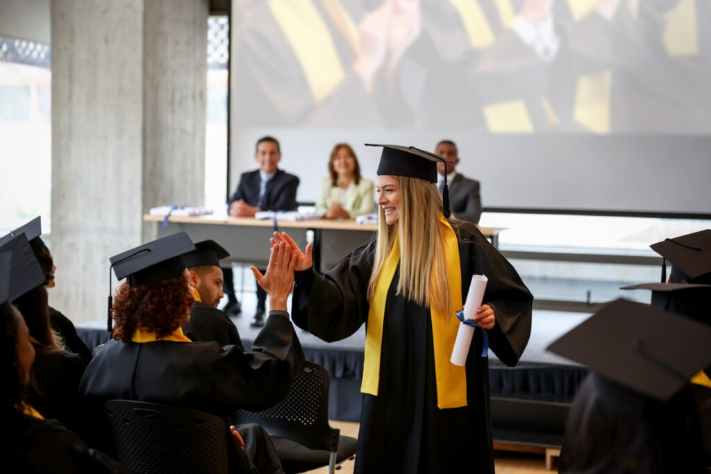 graduate giving high five in aisle