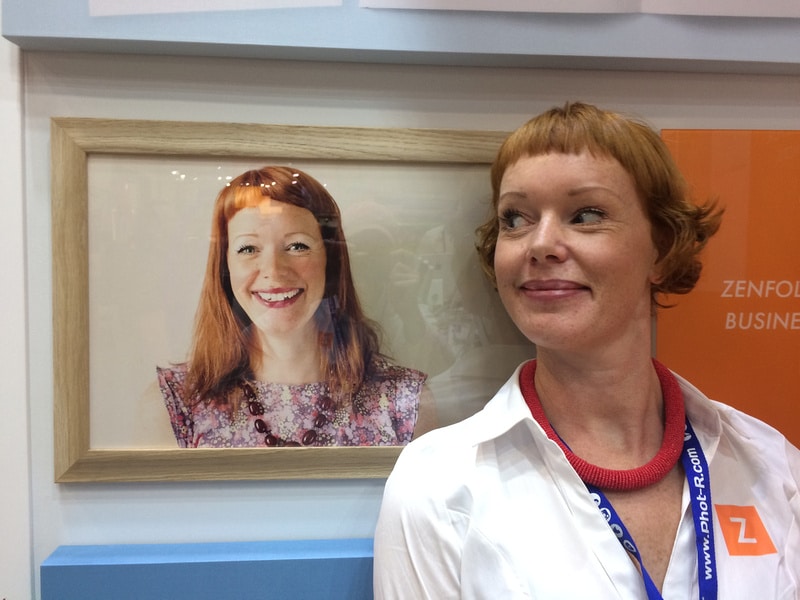 zenfolio employee posing in front of framed photograph